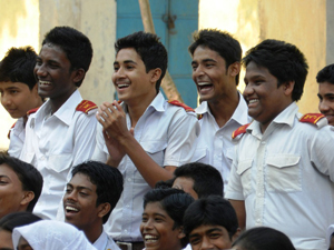 At a theatrical performance in Jessore, Bangladesh, in November 2012, a group of young men applaud as male characters are challenged for committing domestic violence.