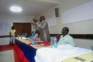 Tom Onyach, of the Luo Council of Elders, speaks at a workshop where community elders drafted a community cultural practice guidebook in an effort to emphasize the role of customary law in fighting disinheritance among widows. Photo courtesy of GROOTS International