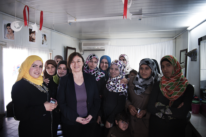 The Director of UN Women's Programme Division, Gülden Türköz-Cosslett celebrates with the first Syrian women graduates of the “Women and Girls Oasis” programme at the Za’atari Refugee Camp, Jordan. Photo credit: Ventura Formicone