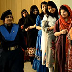 Pakistani women waiting in line to vote in a voting PSA