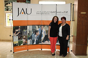 Hiba Varouqa (right) and her former teacher, Sharifa Nofa Bint Nasser (left) standing at the hall of the Jordan Applied University College of Hospitality and Tourism, which is part of UN Women's Gender Equity Seal project. Photo: Maria Fanlo