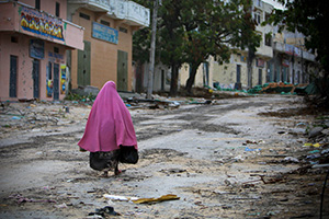 A Somali woman walks through the deserted streets of Bakara Market in central Mogadishu, a city that has endured decades of conflict. 