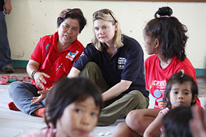 Secretary of State for International Development, Justine Greening MP talks to Corazon 'Dinky' Juliano Soliman, Filipino Secretary of the Department of Social Welfare and Development, at a school in the devastated city of Tacloban in the Philippines on 24 November 2013. Photo: Russell Watkins/Department for International Development