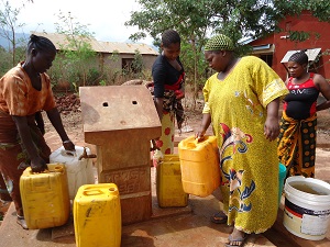 Water kiosk supervisors such as 29-year-old Maria (left) ensure an equitable distribution of clean water in Kingolwira.