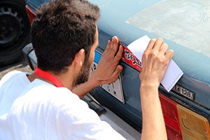 Off campus anti-sexual harassment campaign in which one of 6th of October University students put stickers on cars to promote the campaign's messages. Photo: 6th October University team