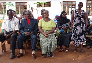 Margareth (right) introduces her fellow water management committee members during their weekly meeting.