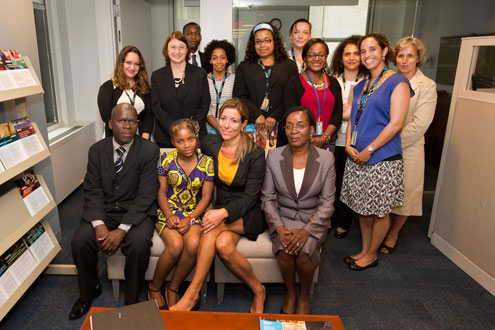 Raquelina and her colleagues pose for a photo with UN Women intergovernmental and programme staff. Photo: UN Women/Ryan Brown