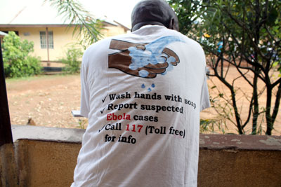 Man wears shirt displaying info about Ebola