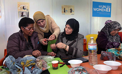 UN Women Executive Director Phumzile Mlambo-Ngcuka takes part in jewelry-making activities during a visit to the Za'atari refugee camp for Syrian refugees during her trip to Jordan from 20 to 23 February 2014. Photo: UN Women Jordan/Abdullah Ayoub