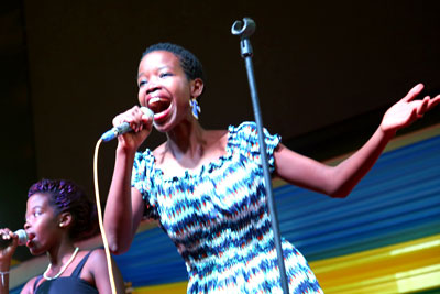 Umuhire Solange Liza, winner of the “Sing yes to Kigali City” song competition, performs at an event at the Amahoro Petit National Stadium in Kigali to implement the community mobilization strategy in the Kigali Safe City Programme, and commemorate the International Day for the Elimination of Violence against Women on 25 November 2014. Photo: One UN Rwanda.