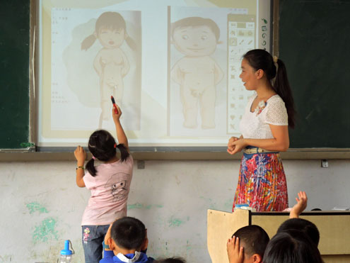 As part of student sexual safety training in Suizhou, central China, a 6-year-old girl circles the private parts of a human body after having learned how to identify them on female and male human bodies. Photo: Xinyu Zhang
