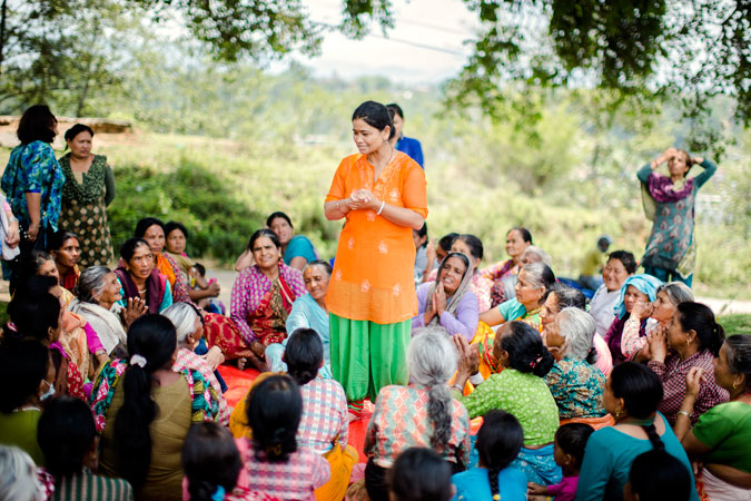 women gather in Dharmasthali to learn more about relief, services and about women's rights