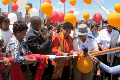 UN Women Executive Director Phumzile Mlambo-Ngcuka cuts the ribbon at Nelson Mandela Bridge, which will be lit up in orange until the end of 16 days of activism, on 10 December to mark UN Women’s “Orange the world” efforts under the UNiTE campaign. Photo: UN Women/Helen Sullivan