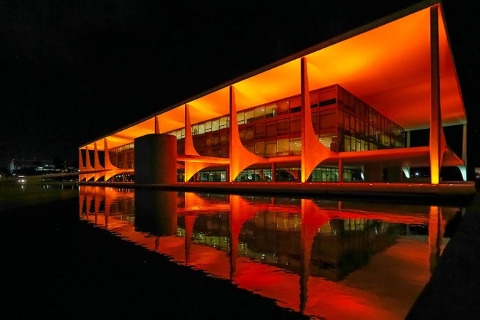 Brazil's Presidential Palace, O Palácio do Planalto, was lit in orange on 19 November, on the final day of the Executive Director's visit to the country, and ahead of the 16 days of activism. Photo: Roberto Stuckert Filho/PR