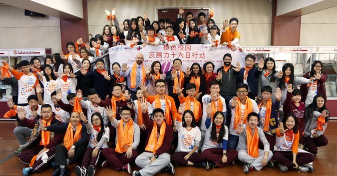 Students at Beijing Normal University and Beijing Royal School wore orange to spread messages on ending violence against women. Photo: UN Women