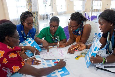 Edith Chukwu (right), helps guide fellow Girl Guides at a train-the-trainers workshop in Zambia to help roll out the “Voices against Violence” non-formal education curriculum. Photo: UN Women/Urjasi Rudra