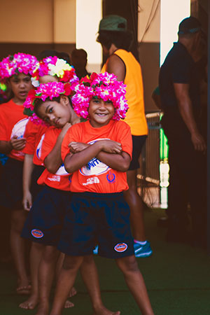 School children wait to escort Manu Samoa and Tonga rugby players to the field. UN Women/Ken Tai Tin