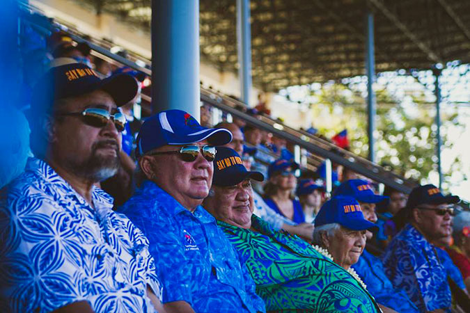 Samoa’s Prime Minister Tuilaepa Aiono Sailele Malielegaoi (third from left, green and blue shirt) attended the match against Tonga on 25 June in support of both Manu Samoa and ending violence against women.  He and other spectators wear hats reading “Say No to Violence” in the front and “Yes to Manu” in back. UN Women/Ken Tai Tin   