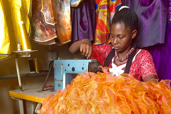Swaumu Hussein adds finishing touches to an evening gown at her tailoring shop in Kasulu, Tanzania. Photo: UN Women Tanzania/Deepika Nath