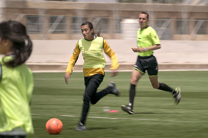 Syrian refugees and Jordanians play football together in Jordan. Photo: UN Women/Christopher Herwig