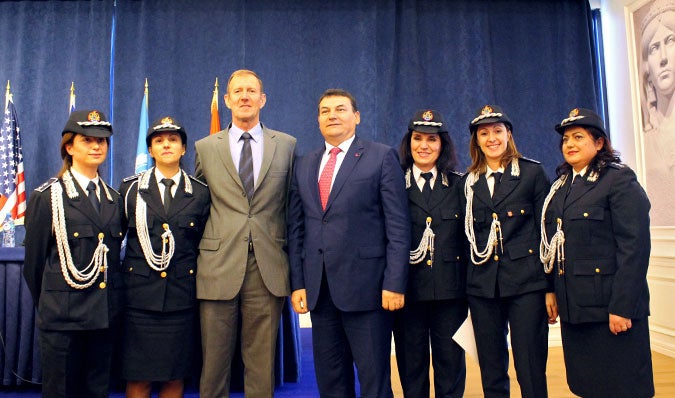 Anila Popa (far right) was one of five women police officers to graduate from the ICITAP-UN Women training in 2015. They stand alongside Bill Morrell, Strategic Police Advisor, ICITAP Albania (centre-left) and the Director of the Albanian State Police, Haki Çako (centre-right), who is also a HeForShe champion.   Photo: UN Women/Besnik Bak