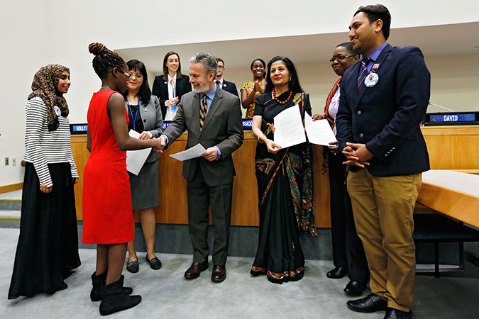 Youth Forum participants present their proposals for inclusion in the CSW Agreed Conclusions to CSW Chair Ambassador Antonio de Aguiar Patriota (middle). Photo: UN Women/Ryan Brown