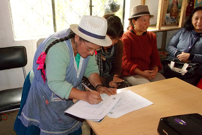 Maria Rosa Suquilanda (left) registers their participation in productive development activities, along with other women producers. Photo courtesy of the Provincial Government of Azuay.