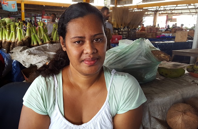 Sofia Talei now has only coconuts to sell at the market after her farm was destroyed by Cyclone Winston. Photo: UN Women/Kasanita Isimeli