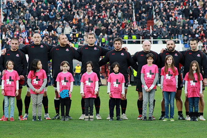 Girls wear HeForShe shirts as they stand with players on the field before the Georgia vs Japan World Cup Qualifier in November 2014 in Tbilisi, Georgia. Photo: UN Women/Maka Gogaladze