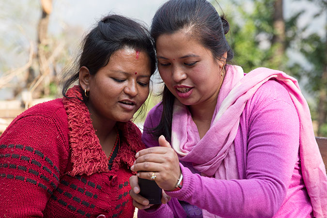 Kalpana Shrestha (left) has received psychosocial counselling for her trauma, from counsellors including Juni as well as Situ (right), pictured here in Sanosirubari VDC -2 in Chautara, Sindhupalchwok, Nepal. Photo: UN Women/N. Shrestha