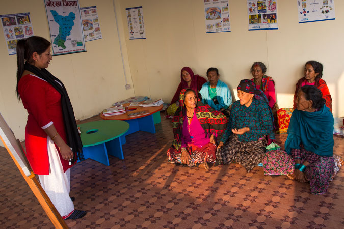 Maali Gurung (seated first row centre), along with other women, attend psychological counseling at the Multi-purpose Women’s Centre in Gorkha Bazaar, which Women for Human Rights (WHR) set up with support from UN Women Nepal. Photo: UN Women/Narendra Shrestha