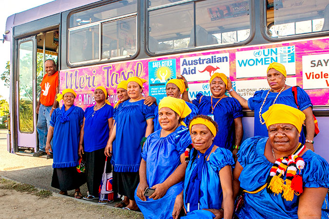 Vendors from Gerehu Market in front of the new "Meri Seif Bus".  Mr. Powes Parkop, Governor of the National Capital District, Port Moresby, Papua New Guinea and Ms. Phumzile Mlambo-Ngcuka, Executive Director of UN Women cut the ribbon on the new Meri Seif bus. The third bus in the Safe Transport programme under Safe Cities launched in the Safe Cities event during the 16 Days of Activism to End Gender-Based Violence. Photo: UN Women/Johaness Terrra