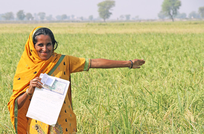 Durdana, a once landless woman farmer, proudly shows off her land and Land Tenancy Agreement in Dadu District, Sindh Province, Pakistan. Photo: UN Women/Faria Salman