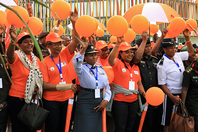 During the 16 Days of Activism, Attendees and Officials of the Africa Convention of Women in Security Organs hold orange balloons and umbrellas at the Walk to end Gender Based Violence held on 29 November 2016 in Kigali, Rwanda.  Photo: UN Women/Tumaini Ochieng