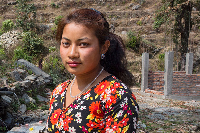 Sita Shrestha stands infront of community tab at Irkhu VDC-7 in Sindhupalchwok, Nepal. Photo: UN Women/N. Shrestha