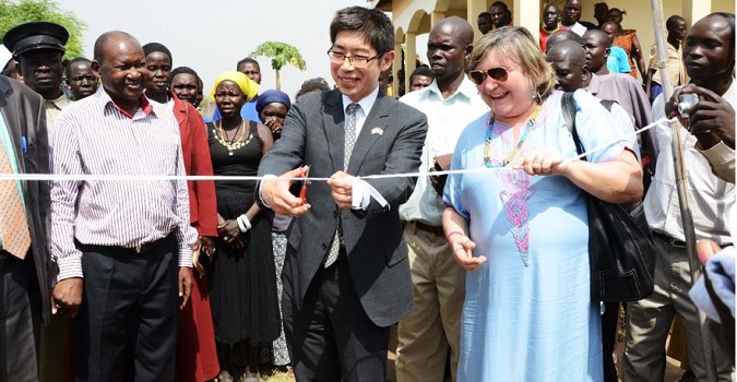 UN Women Deputy Country Representative for South Sudan, The Ambassador of Japan to South Sudan, H.E. Kiya Masahiko and the UN Women Director of Programmes, Ms Maria Noel Vaeza cutting a ribbon as they hand over the resilience building equipment. Photo Credits: UN Women/Rose Ogola