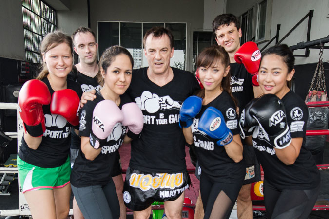 Stephan Fox (middle) with players and staffs of International Federation of Muaythai Amateur. Photo: UN Women/Pathumporn Thongking