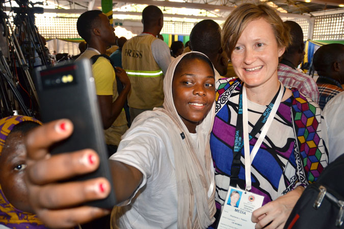 Taking selfies with a fellow woman radio reporter and member of Tanzania Media Women’s Association among the press pack at the 2015 awarding of certificates by the National Electoral Commission to the president and vice-president elect on 30 October 2015. Photo: UN Women Tanzania