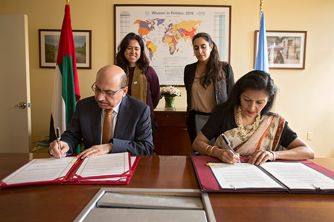 UN Women Deputy Executive Director Lakshmi Puri and UAE Assistant Minister for Legal Affairs Abdulrahim Yousif Al Awadi sign an agreement between UN Women and UAE to open a new UN Women Liaison Office in Abu Dhabi on 15 July. Photo: UN Women/Ryan Brown