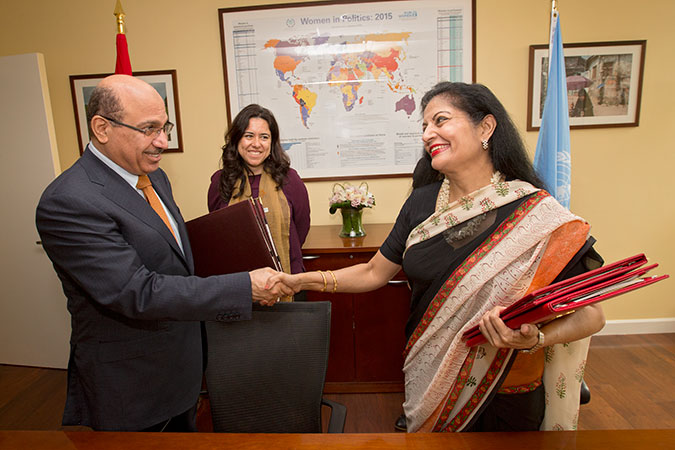 UN Women Deputy Executive Director Lakshmi Puri and UAE Assistant Minister for Legal Affairs Abdulrahim Yousif Al Awadi shake hands at the signing of an agreement to open a new UN Women Liaison Office in Abu Dhabi. Photo: UN Women/Ryan Brown