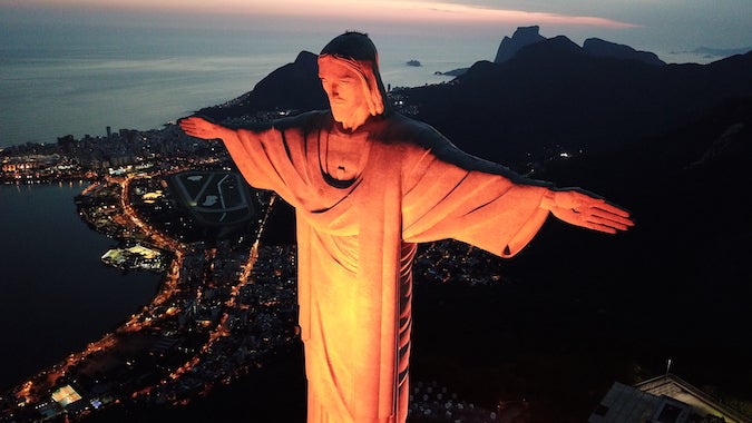 Christ the Redeemer in Rio de Janiero, Brazil is bathed in orange light. Photo: UNIC/Pedro Andrade