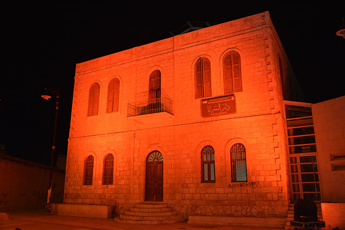 The historic building of Dar Al Saraya in Madaba, Jordan, lit in orange. Photo credits: JNCW/BeamEvents