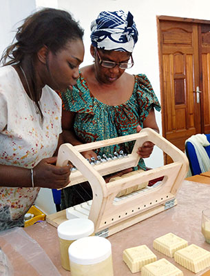 Blah Pauline Ninhouet during a soap-cutting exercise with UN Women expert, Mame Khary Diene Expert in a production workshop for the preparations of the International Exhibition of Agriculture in Abidjan. Photo: UN Women/Alpha Ba