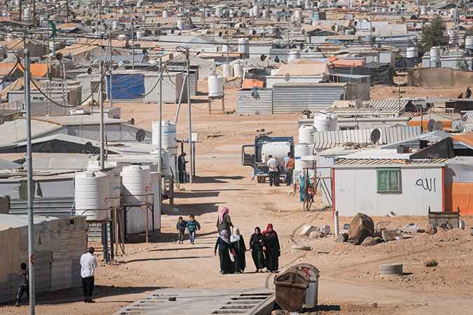 Women walk through the Za'atari camp. Photo: UN Women/Christopher Herwig