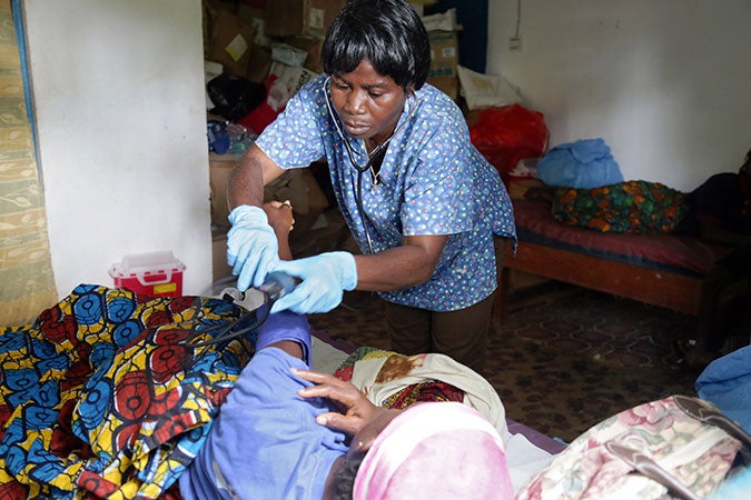 La partera Lorina Karway atiende a una nueva madre en la sala de posparto de la Clínica Bodowhea en River Cess, Liberia. Foto: ONU Mujeres/Winston Daryoue.