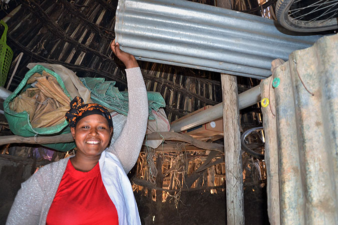  Kebela Guru shows the corrugated iron sheets she purchased to build a new home for herself. Photo: UN Women/Fikerte Abebe