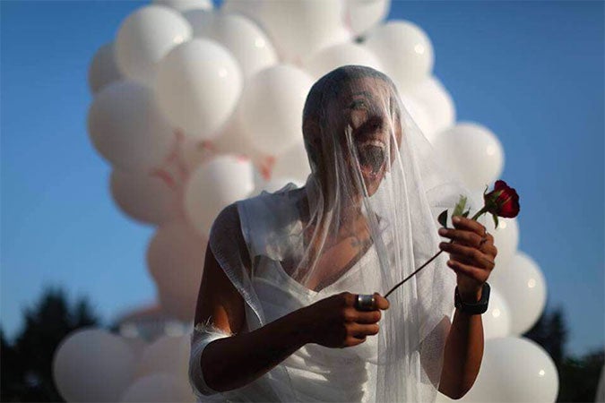 A civil society activist outside of the parliament building in Beirut celebrates the abolishment of article 522 from the Lebanese Penal Code on 17 August 2017. Photo: ABAAD