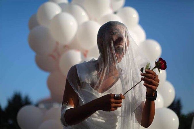 A civil society activist outside of the parliament building in Beirut celebrates the abolishment of article 522 from the Lebanese Penal Code on 17 August 2017. Photo: ABAAD