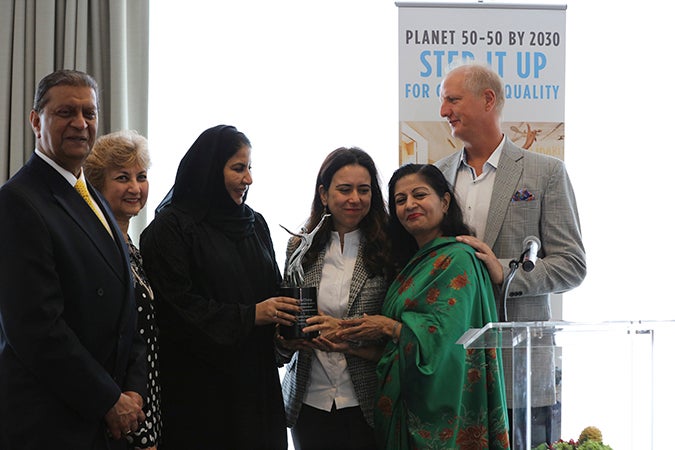 Ambassador Lana Nusseibeh, Permanent Representative of the UAE to the UN and Noura Khalifa Al Suwaidi, Director-General, General Women's Union of the UAE, receive the Agent of Change Award on behalf of Her Highness Sheikha Fatima bint Mubarak, Chairwoman of General Women’s Union of UAE. They are joined in this photograph by Lakshmi Puri, Assistant Secretary-General of the United Nations and Deputy Executive Director of UN Women; Amir Dossal, President of the Global Partnership Forum; Tas Dossal from the Global Partnership Forum; and the artist, Spar Street. Photo: Aditya Wicaksono