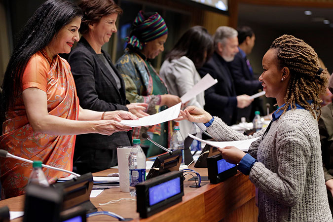 Youth hand over their Declaration to the panellists at the closing of CSW61 Youth Forum. Photo: UN Women/Ryan Brown